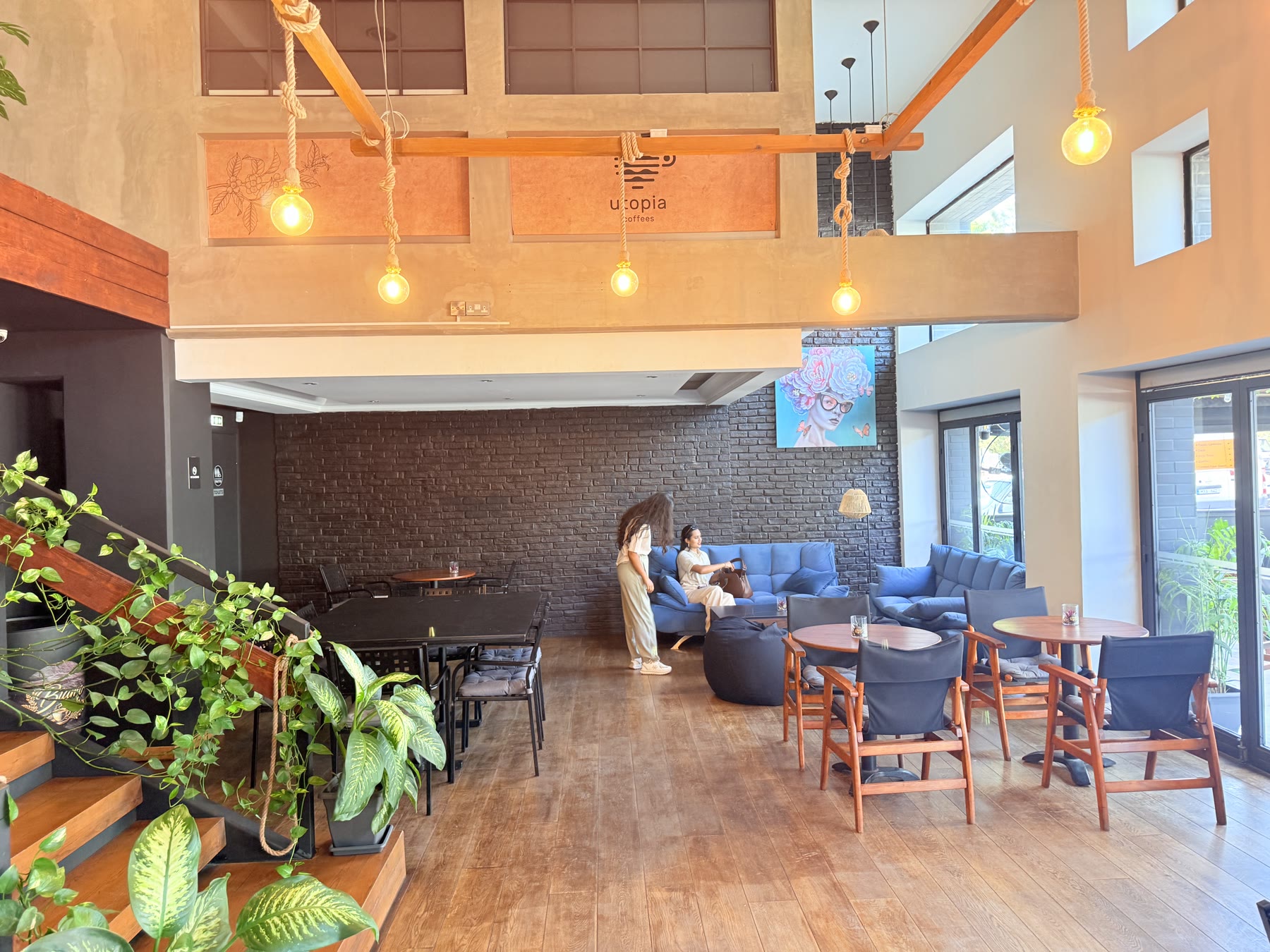Warm seating, plants and hanging lights inside Biamo Café